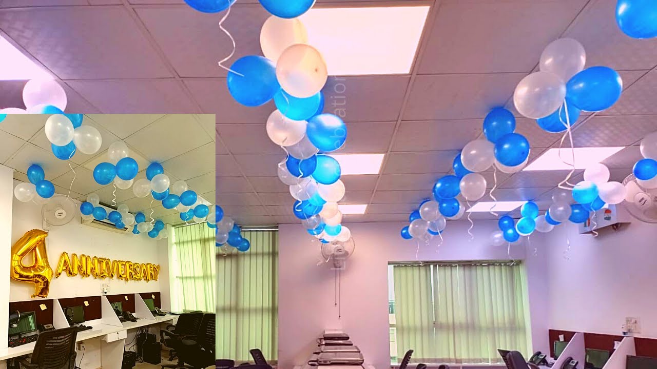 Decorative balloons in blue, white, and gold in an office setting with '4 Anniversary' text.
