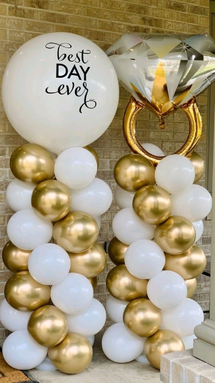 Decorative setup with balloons and a large diamond ring, featuring 'Best Day Ever' text.