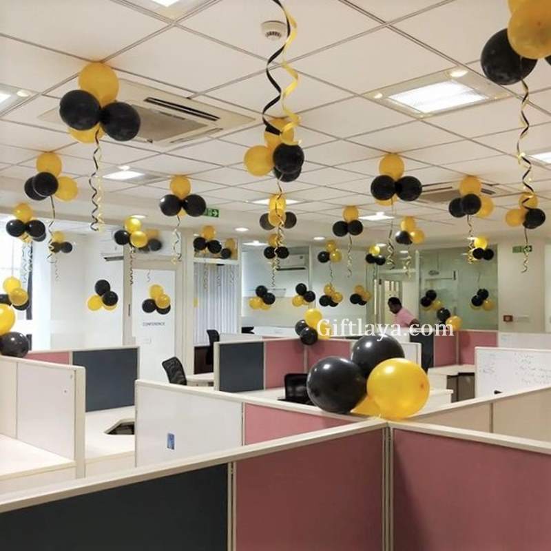 Decorative balloons and streamers in an office setting with 'Giftlava' branding.