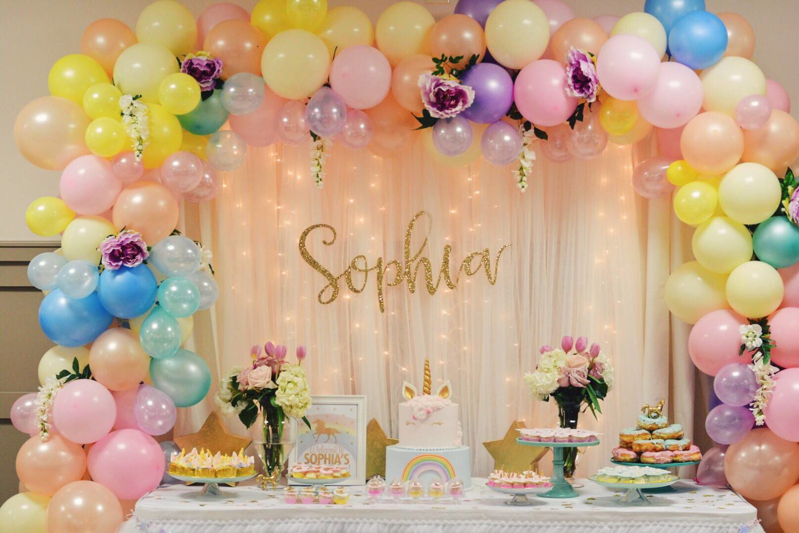 Pastel color balloon arch with flowers - PartyMonster.ae